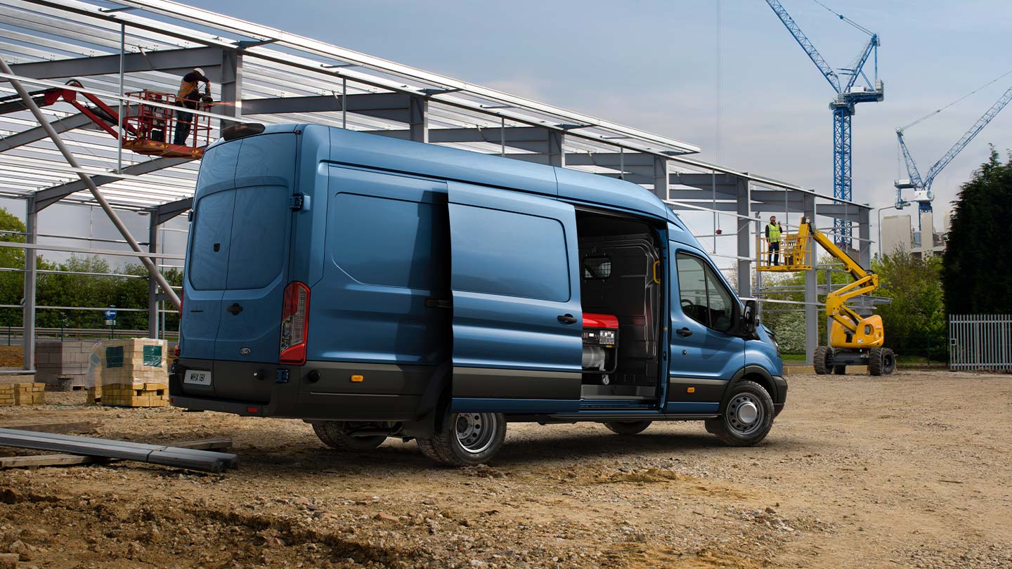 Ford Transit panel van with open sliding side door.