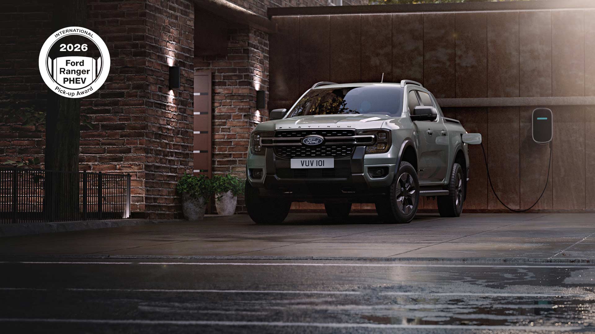 Silver Ford Ranger PHEV charging next to a residential brick building.