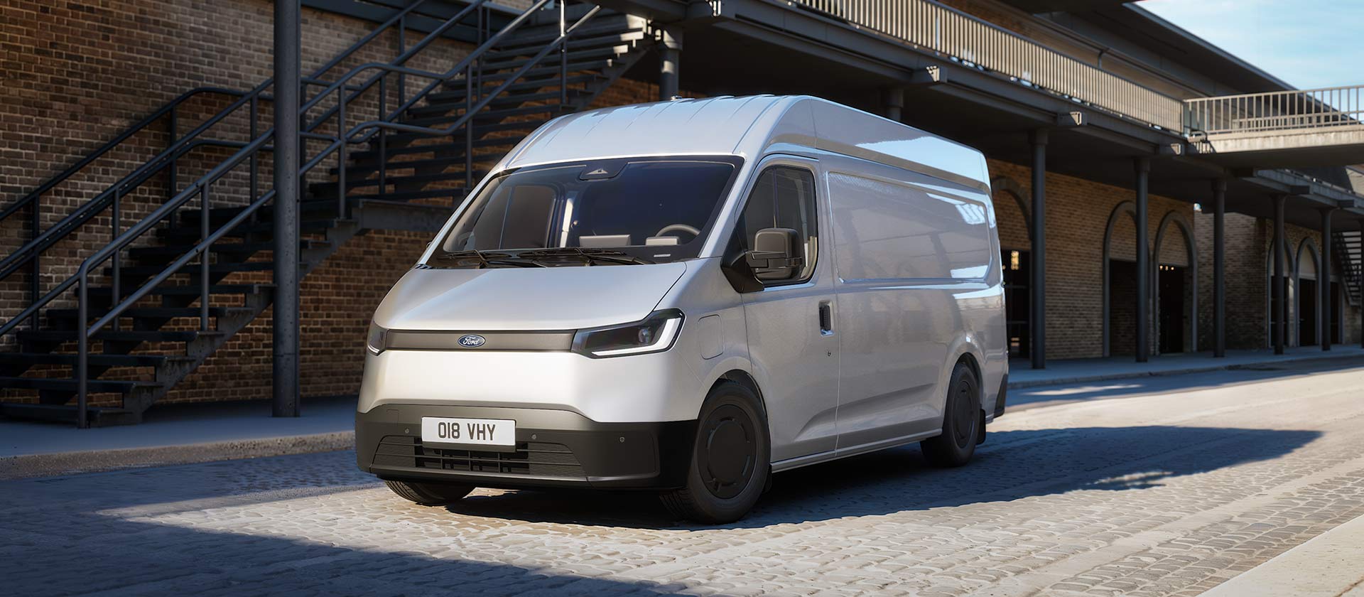 White All-New Ford Transit City L2H2 van parked in in front of a brick building.