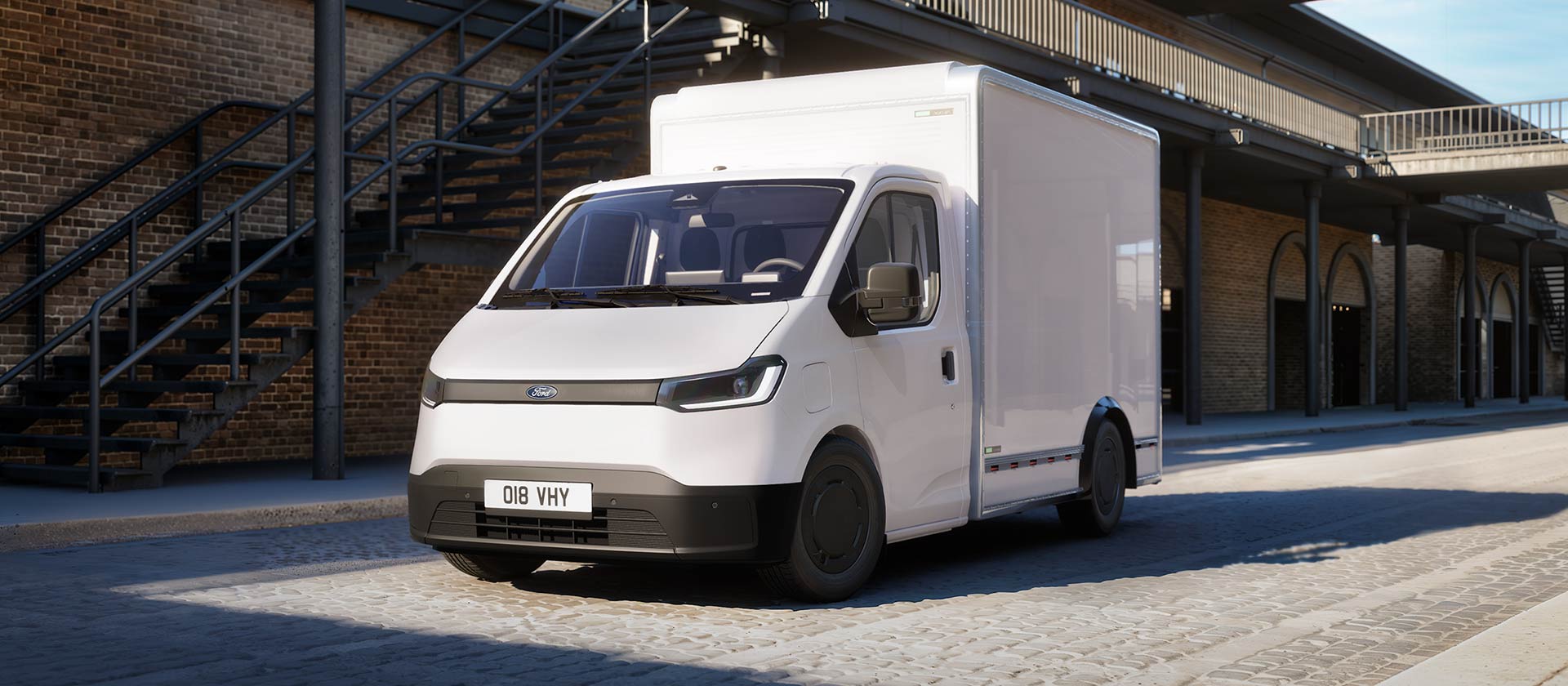 White All-New Ford Transit City Chassis Cab van parked in front of a brick building.