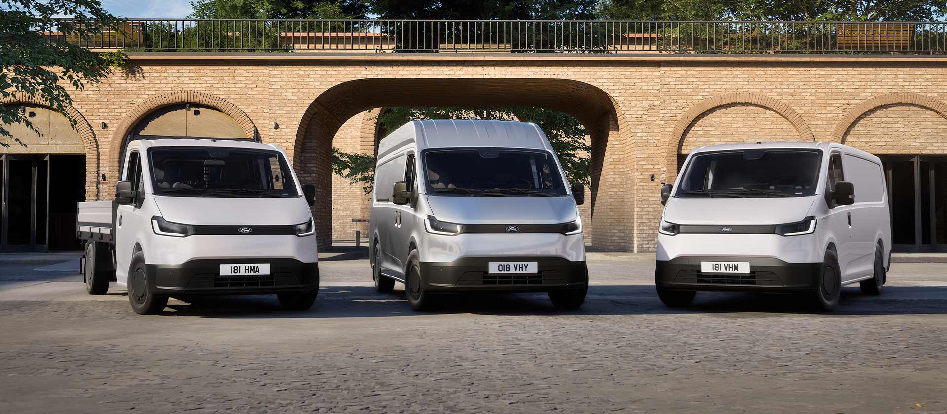 All-New Ford Transit City L1H1, L2H2 and Chassis Cab models parked in front of railway arches.