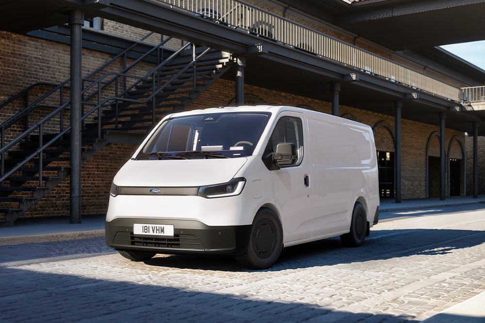 White All-New Ford Transit City® L1H1 van parked in in front of a brick building.