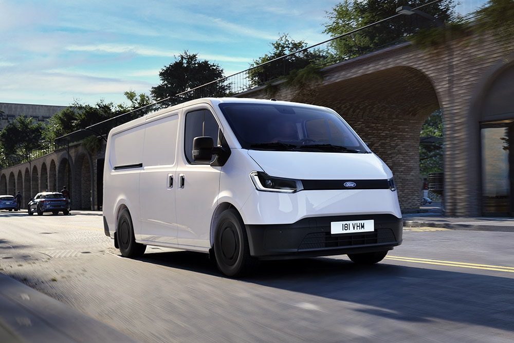 White All-New Ford Transit City® L1H1 van driving on a city street.