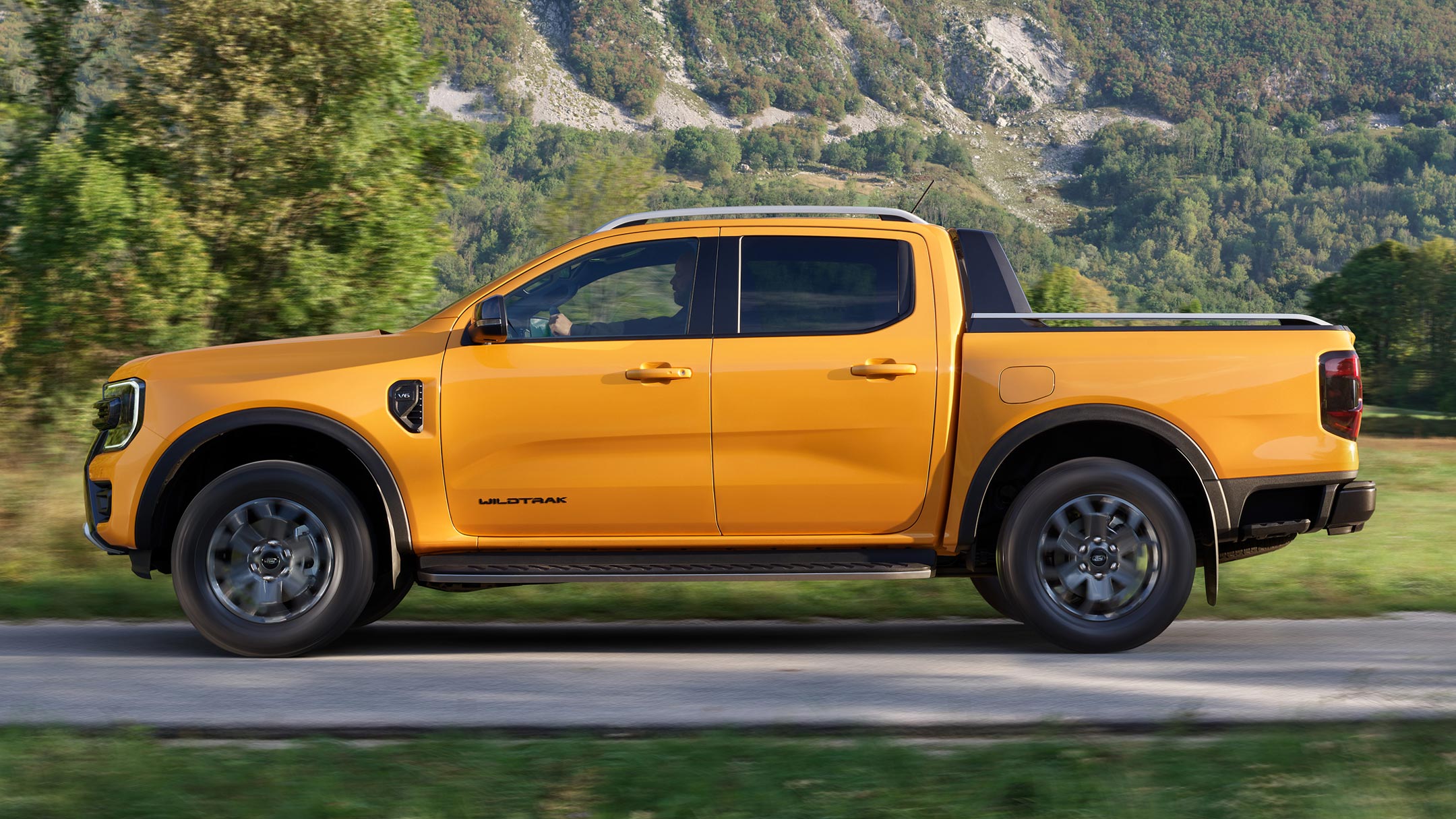 Ford Ranger side view driving on county road