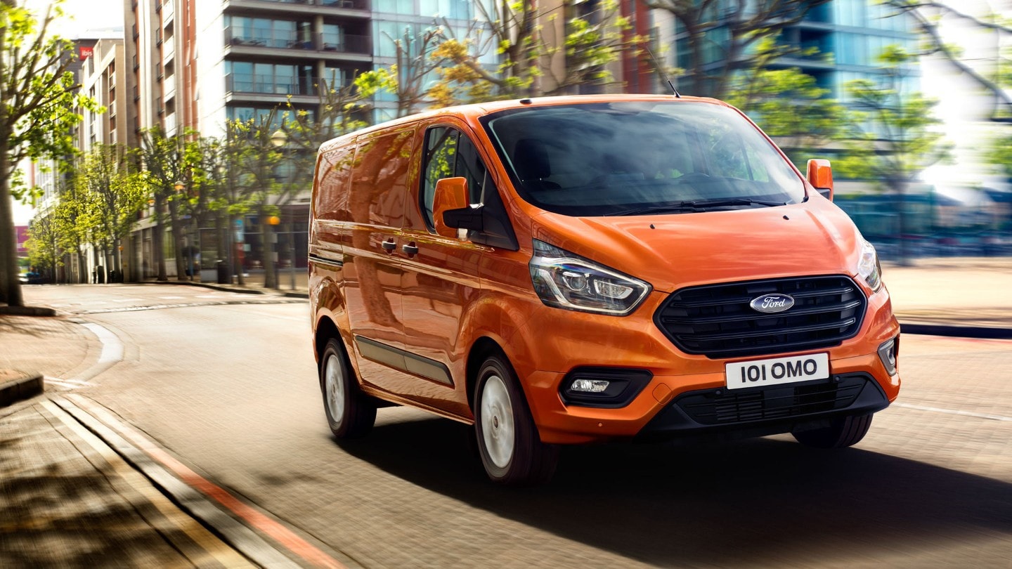 Orange Ford Transit Custom driving