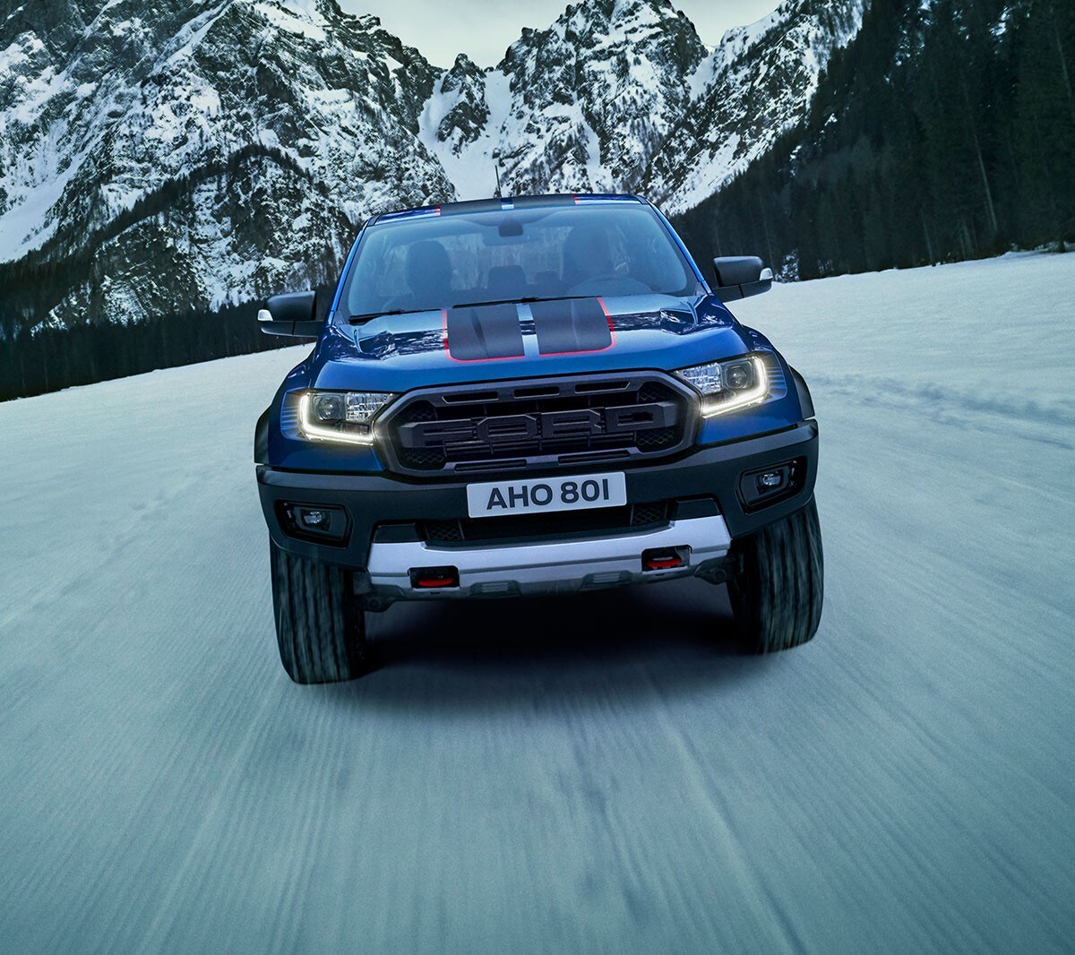 Blue Ford Ranger Raptor driving on snowy road