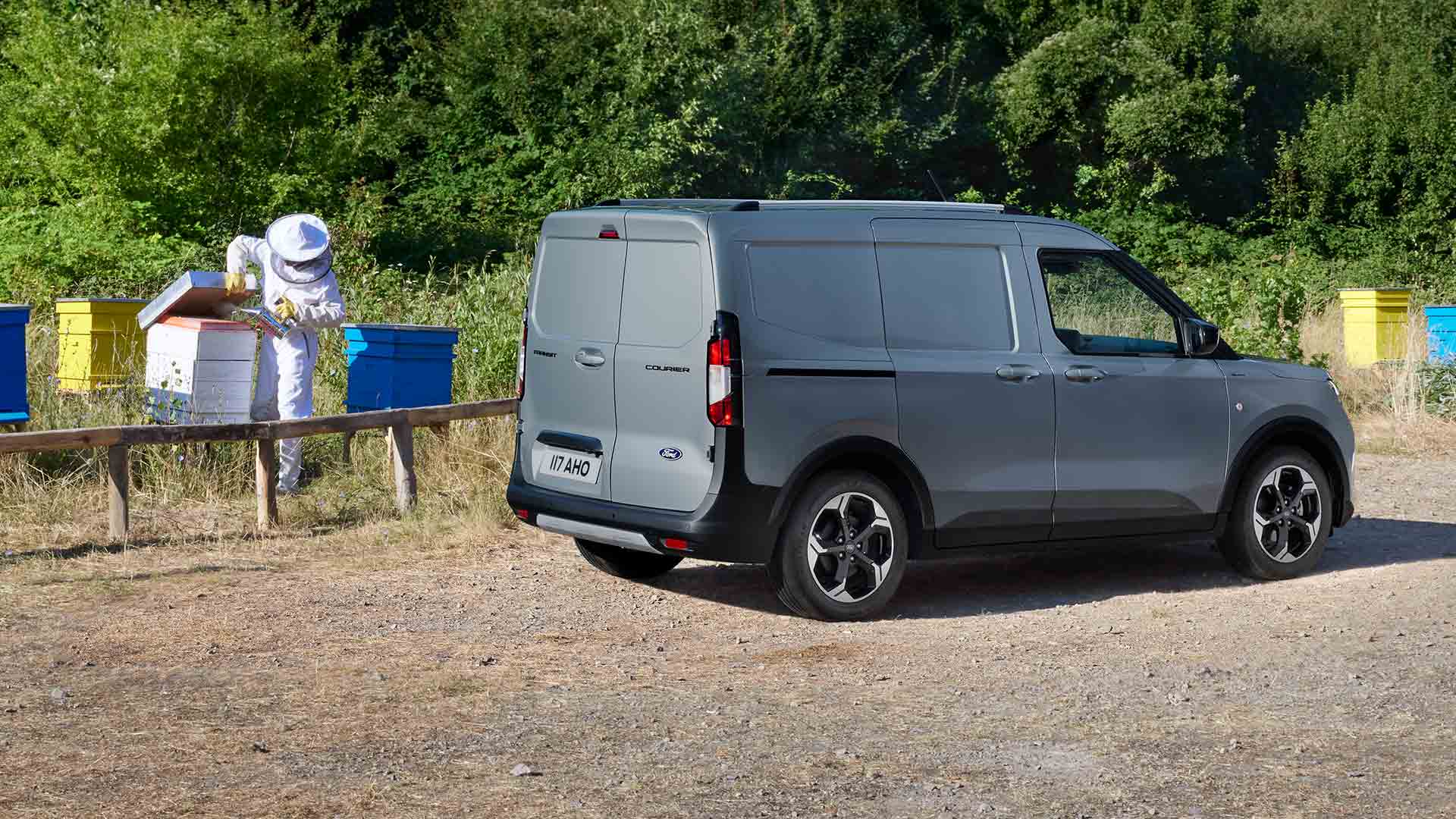Beekeeper working next to a new Ford Transit Courier