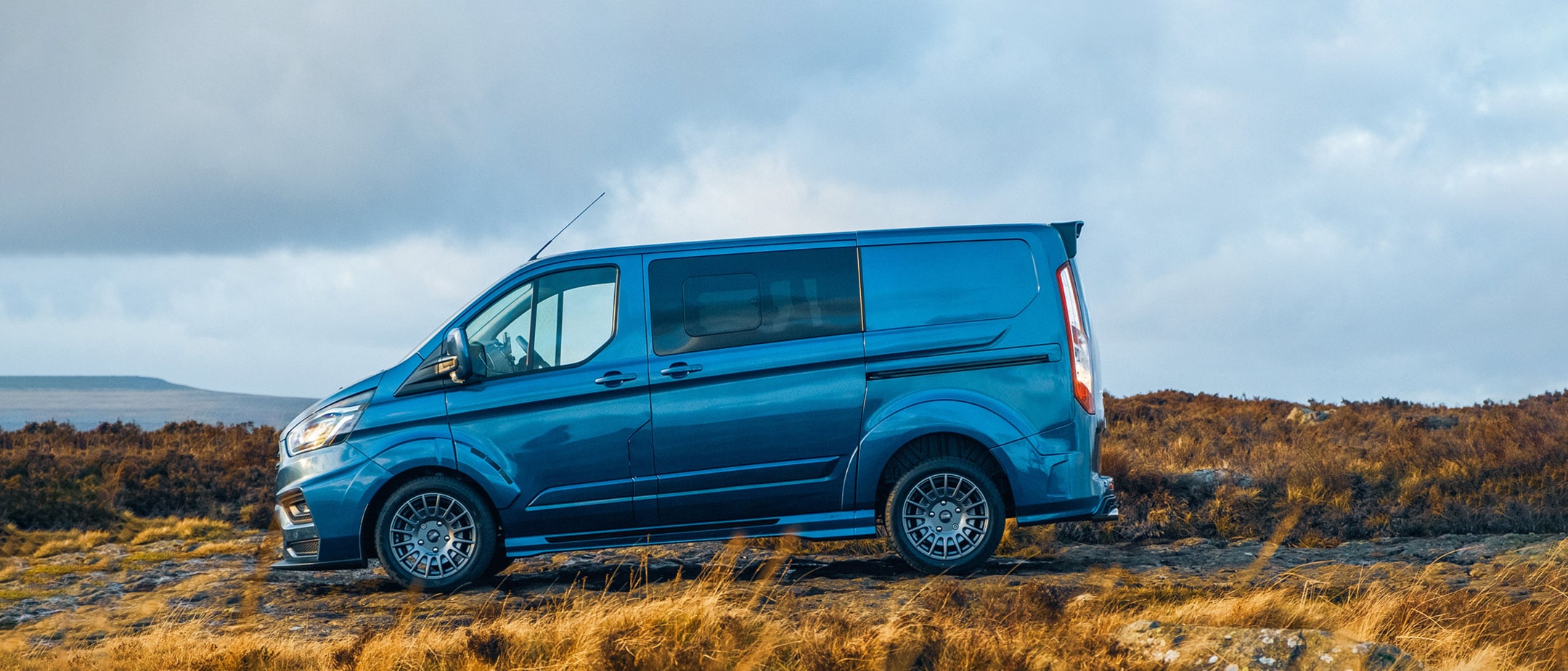 White Ford Transit Custom MS-RT driving through the countryside White Ford Transit Custom MS-RT driving through the countryside