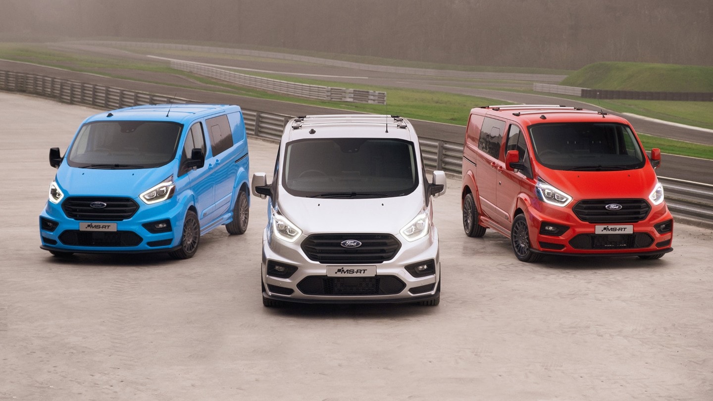 3 Ford Transit Custom MS-RT vans parked at a racing course