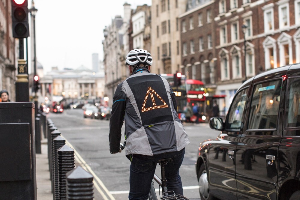 Cyclist wearing Ford emoji jacket