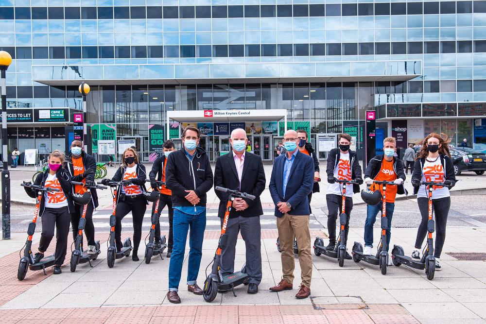Ford team wearing masks on scooters