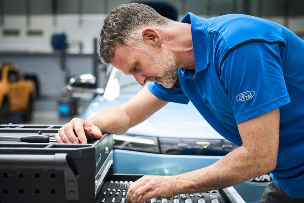Close-up of a Ford-approved technician working in a garage.