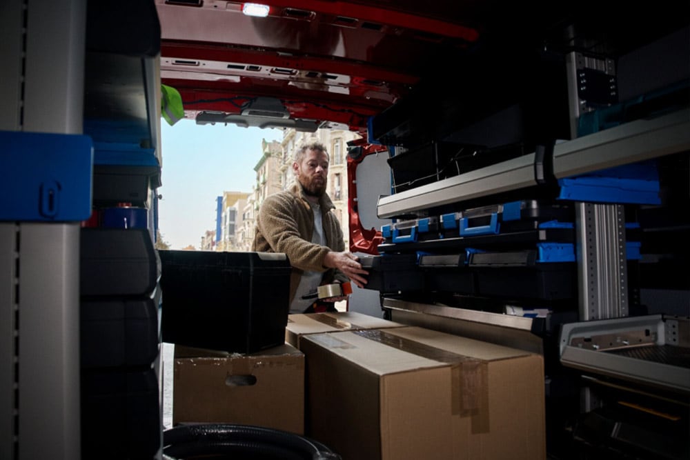 Interior view of a man loading a Ford van.