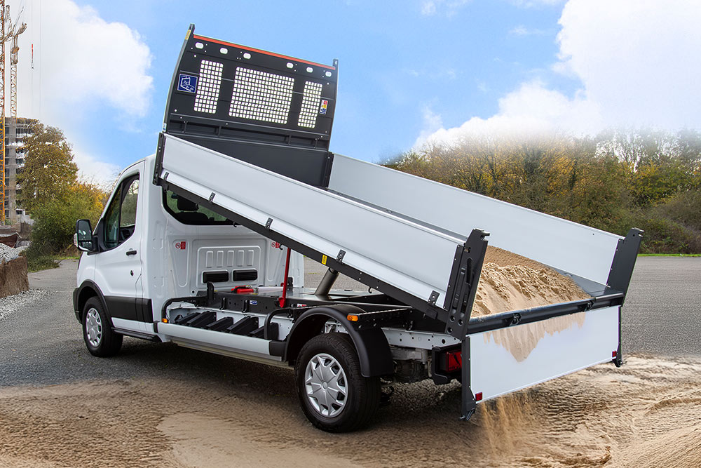 White Ford Pro Chassis Cab with a raised flatbed parked at a construction site