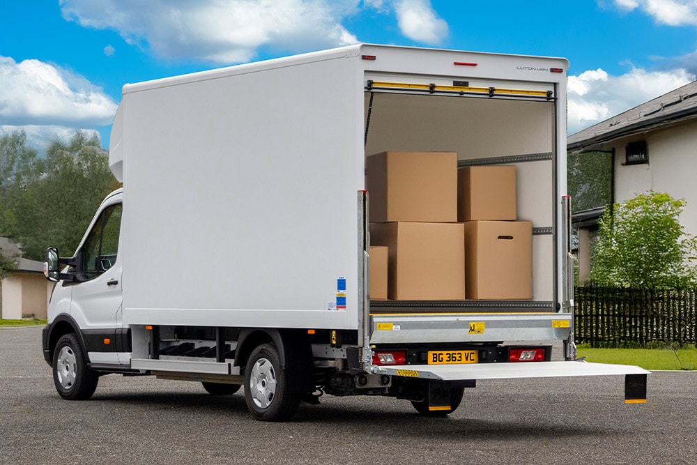Rear view of a white Ford Pro Chassis Cab converted into a delivery truck.