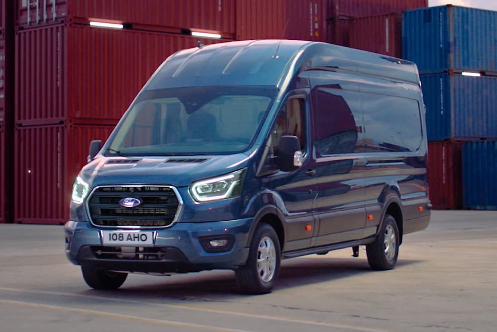Modem data icons displaying around a blue Ford vehicle in a shipyard setting.