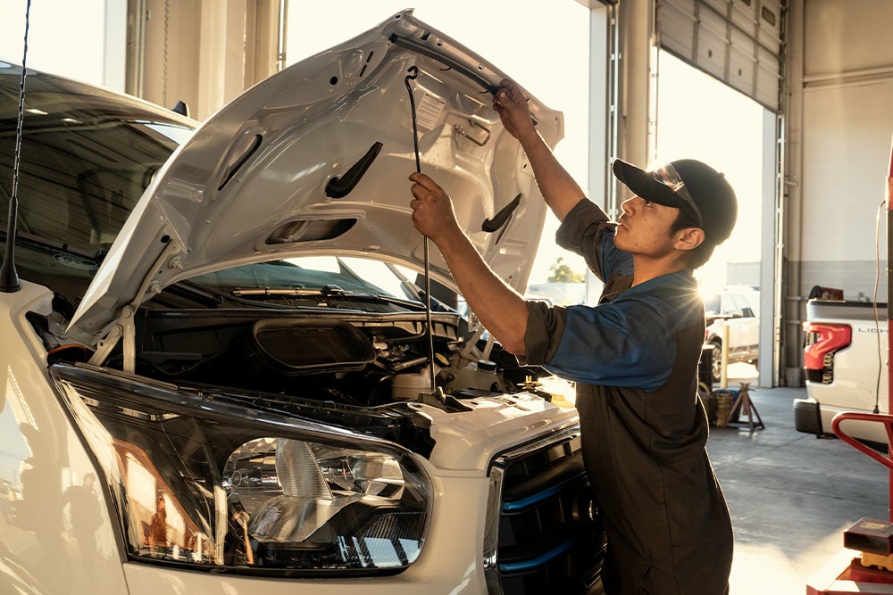 Ford mechanic carrying out maintenance on a Ford Transit van.