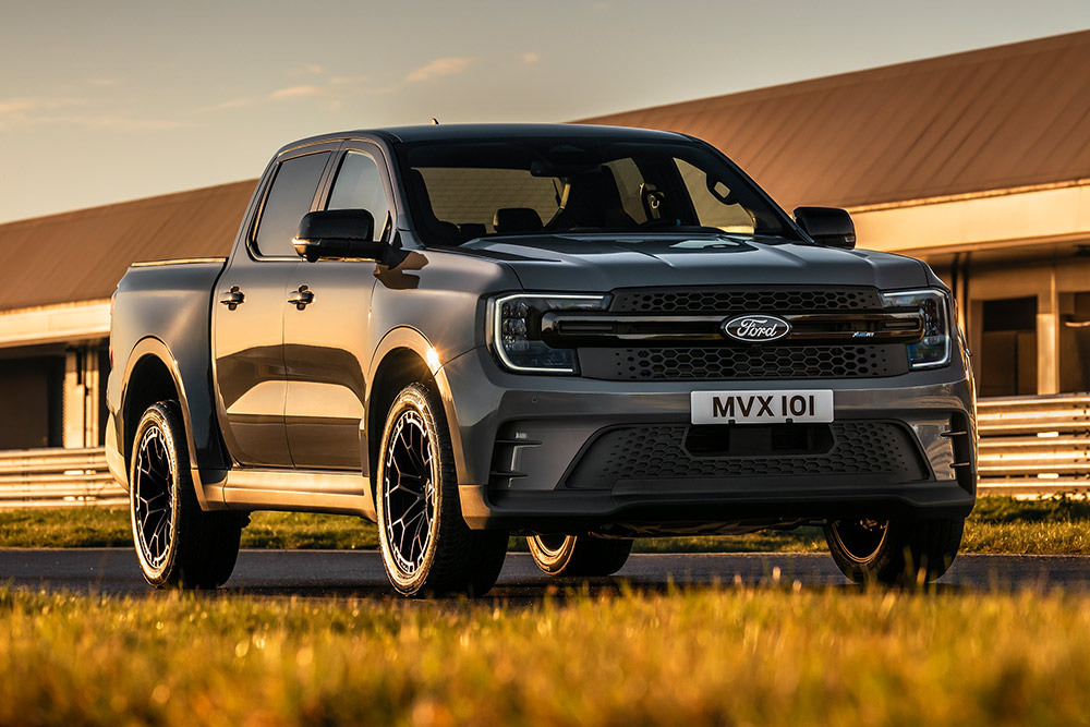 Silver Ford Pro Ranger Plug-in Hybrid parked in front of an industrial building.