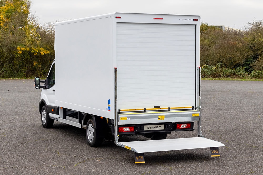 Rear view of a white Ford Pro Chassis Cab converted into a delivery truck.