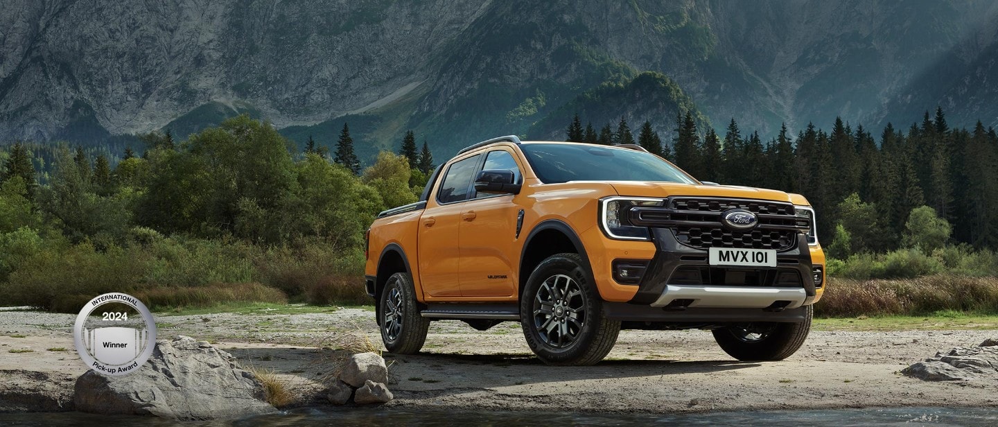 Ford Wildtrak parked near mountains 3/4 front view