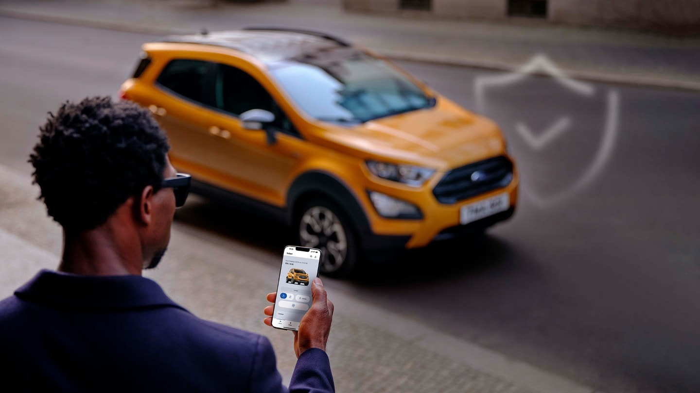 A man coming to the yellow car