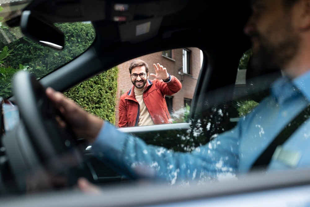 Keys being passed from a Ford representative to a customer