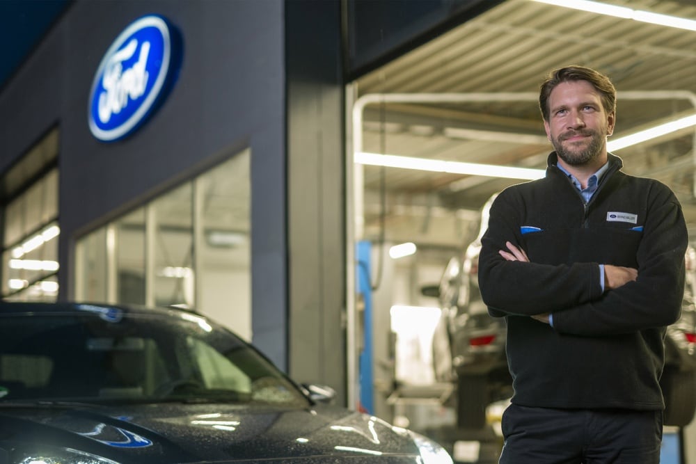 Technician in front of workshop