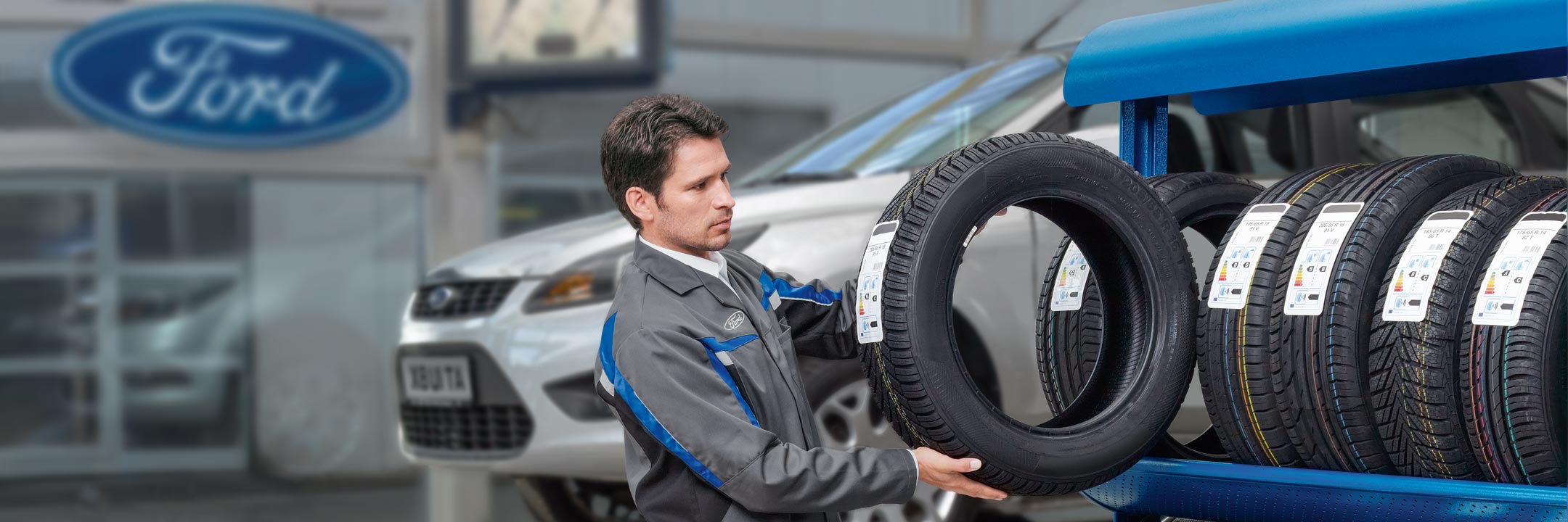 Ford repairman lifting a tyre