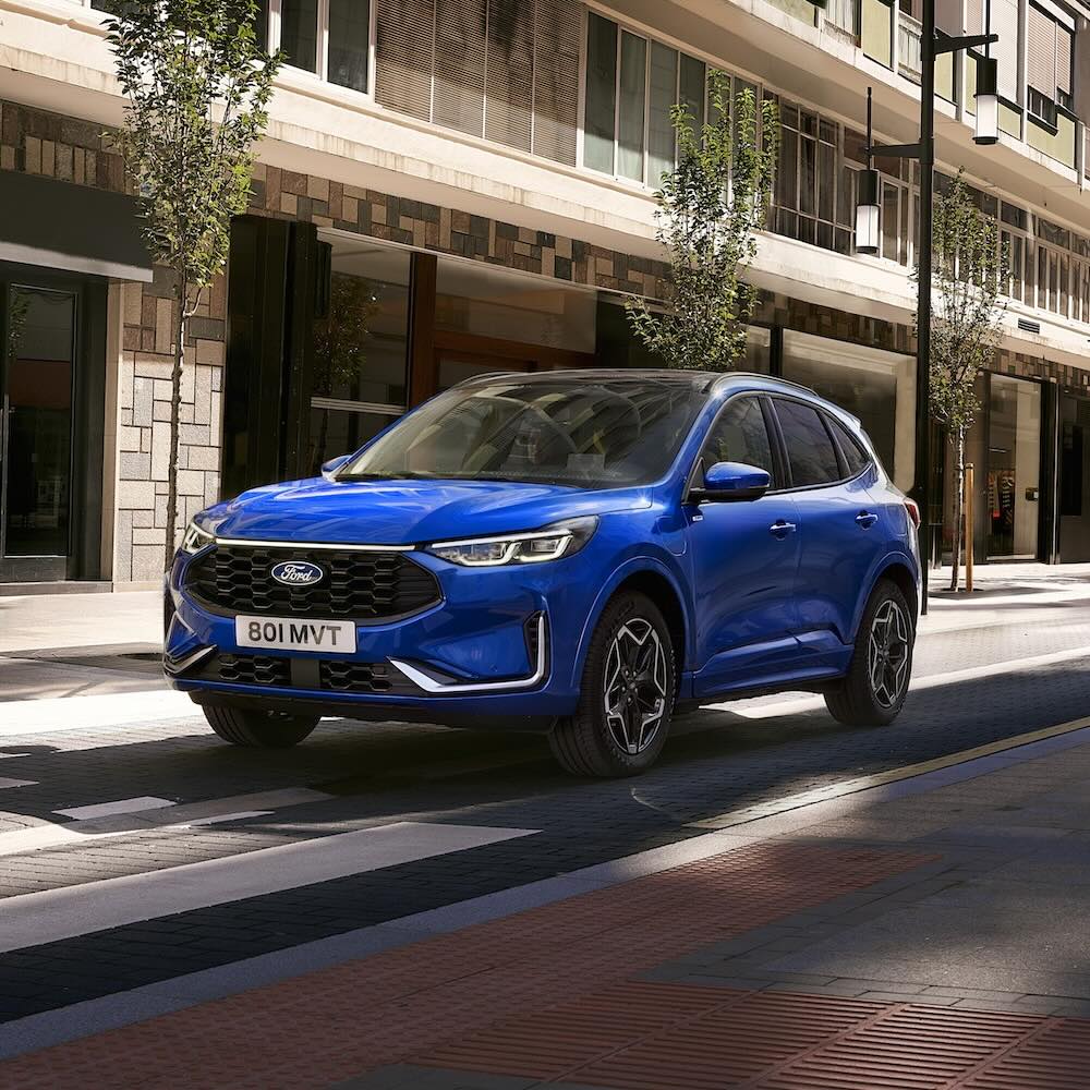 Blue Kuga driving on road