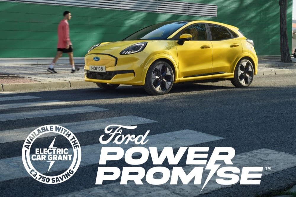 Side view of a yellow electric Ford Puma Gen-E® parked by the side of the road. Image features a Ford Power Promise logo.
