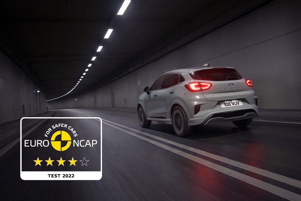 Grey Ford Puma driving through a concrete tunnel, next to an Euro NCAP logo.