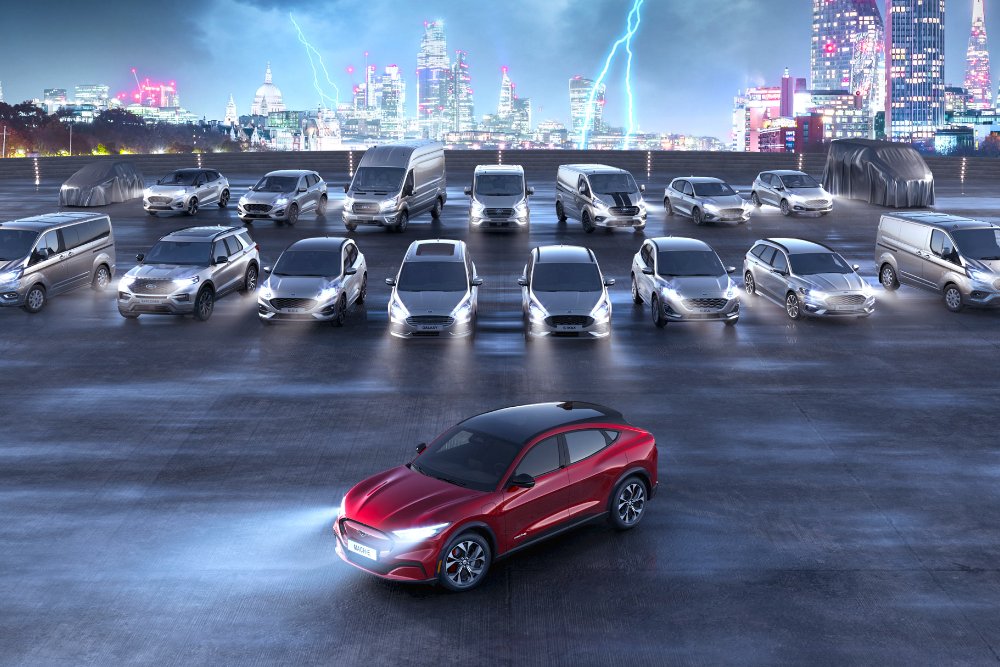 A red Ford Mach-E parked in front of other Ford models