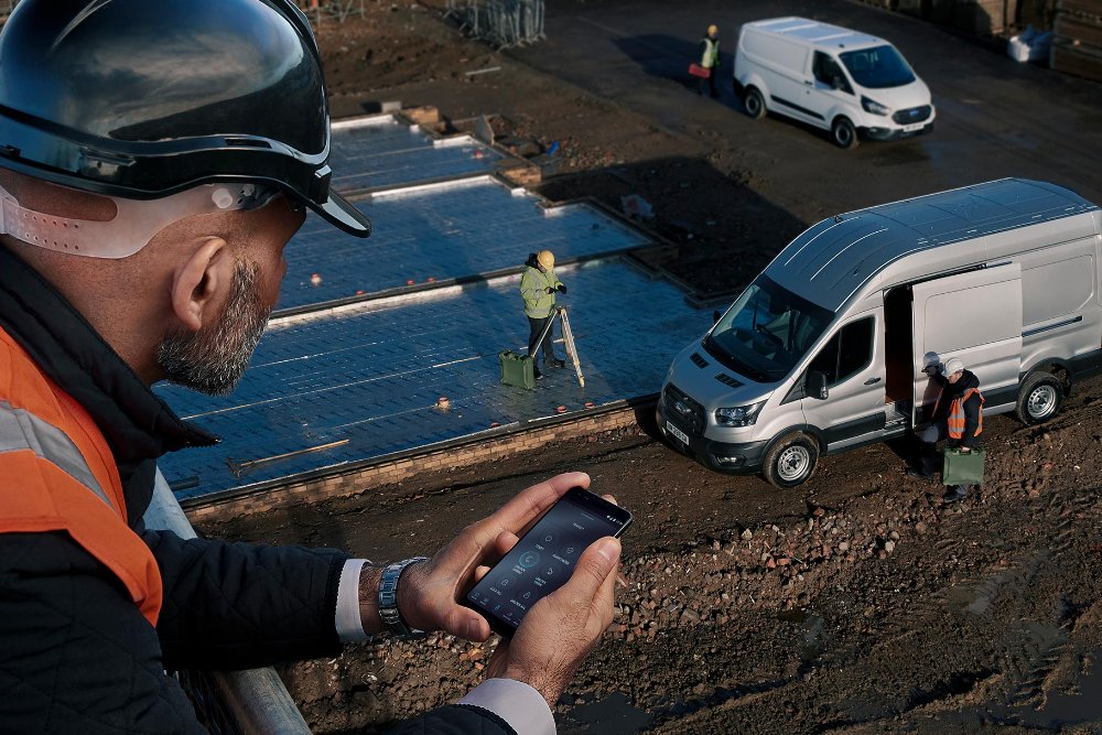 man in high viz jacket in building site looking at his mobile phone with FordPass Pro
