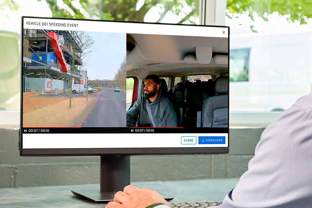 Monitor displaying dashcam footage of a driver on the road