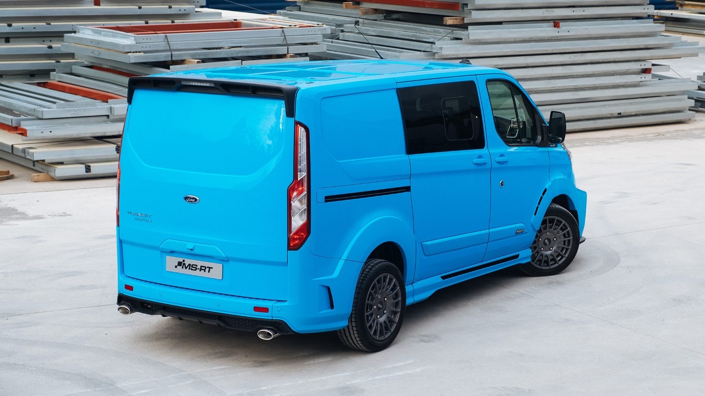 Ford Transit Custom MS-RT 3-quarter view from behind, parked inside a warehouse