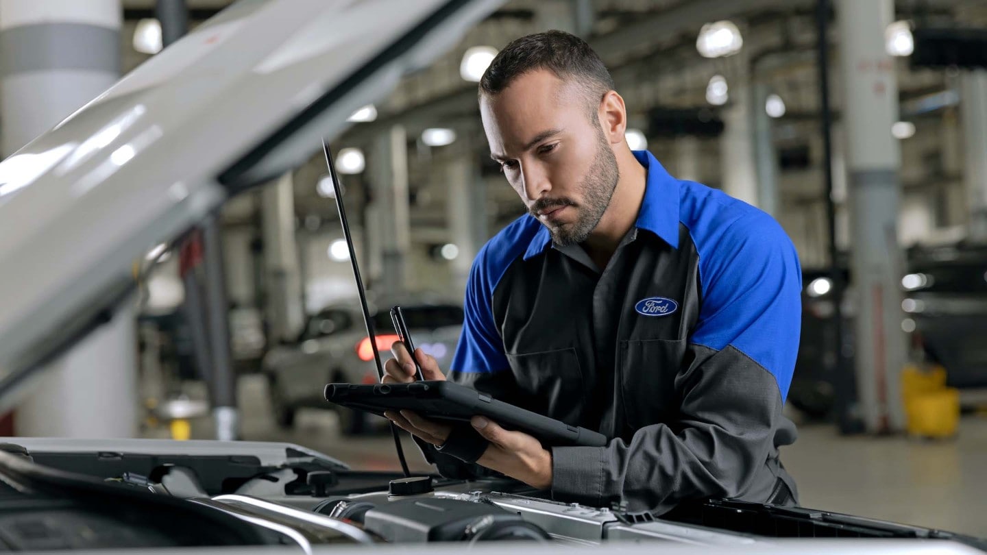 Ford worker holding an engine model