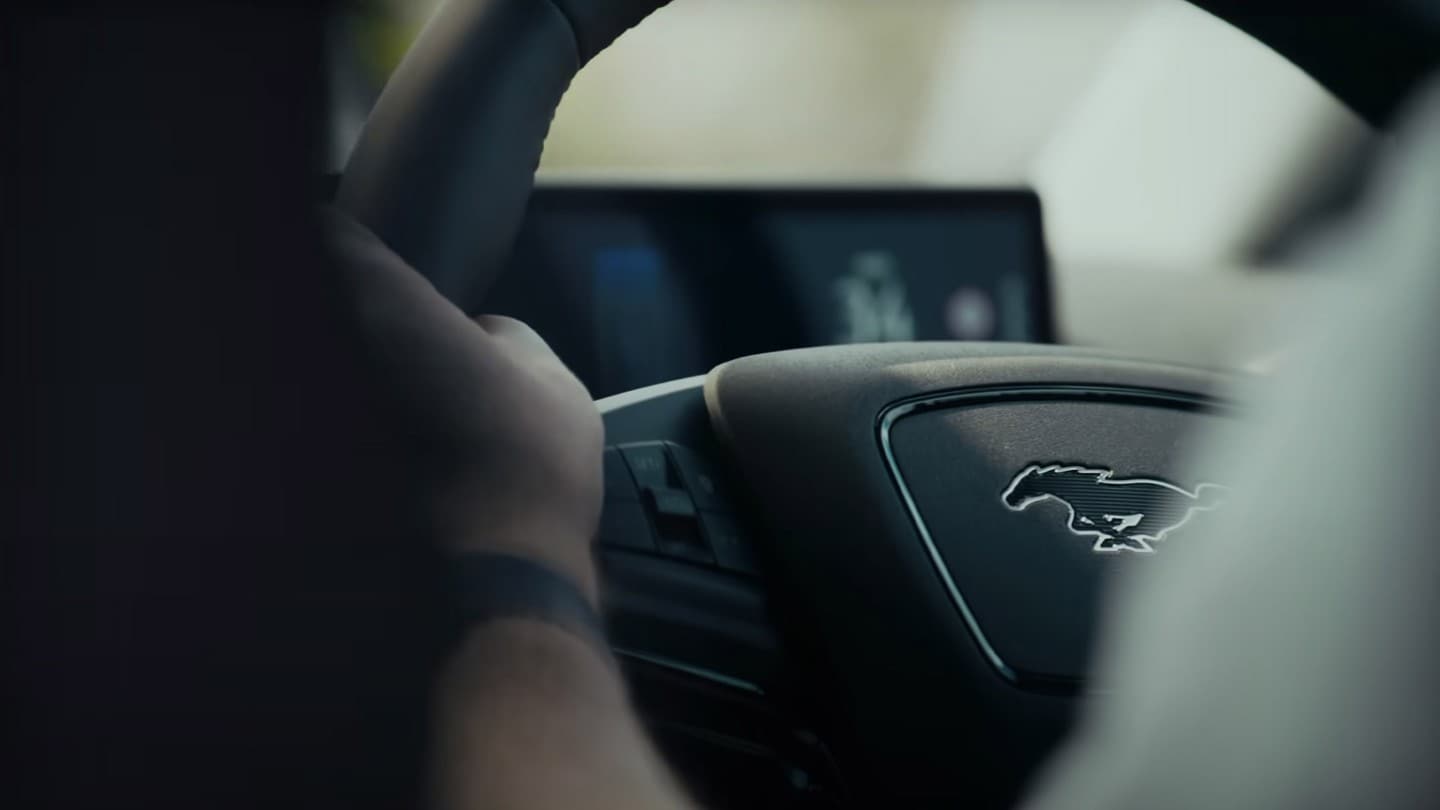 A close-up of Peter’s hands on the wheel of his Mustang Mach-E