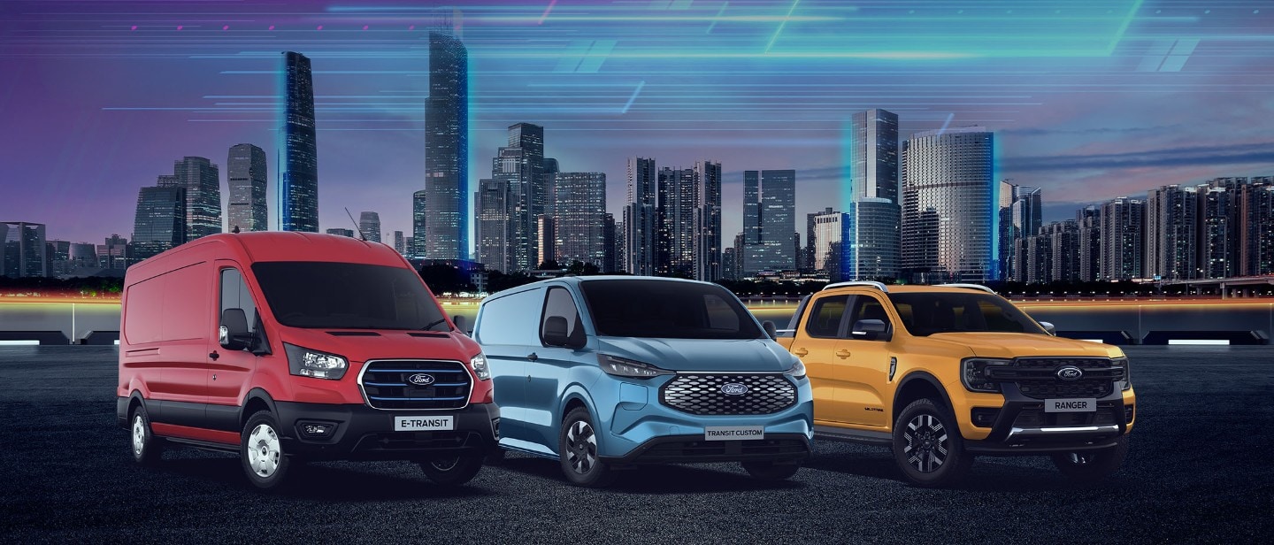 Red E-Transit, blue E-Transit Custom, and yellow Ford Ranger in front of a city skyline.