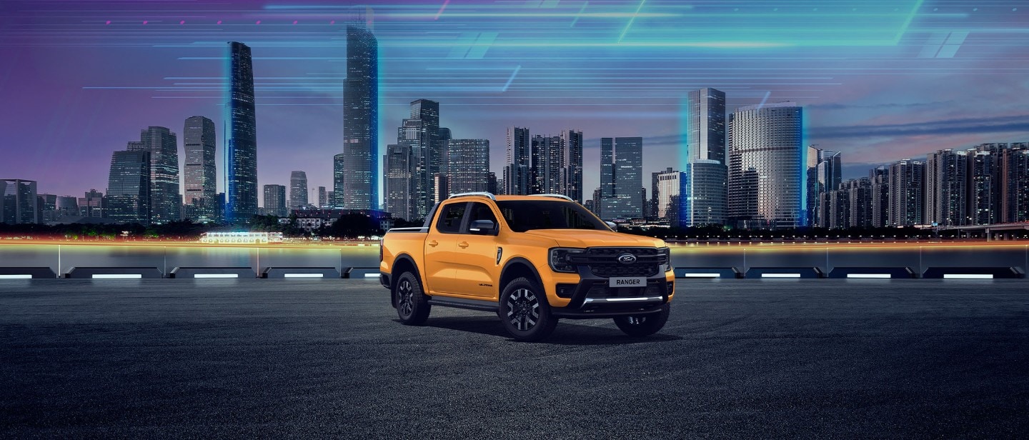 A yellow Ford Ranger pickup truck parked in front of a city skyline with an abstract sky.