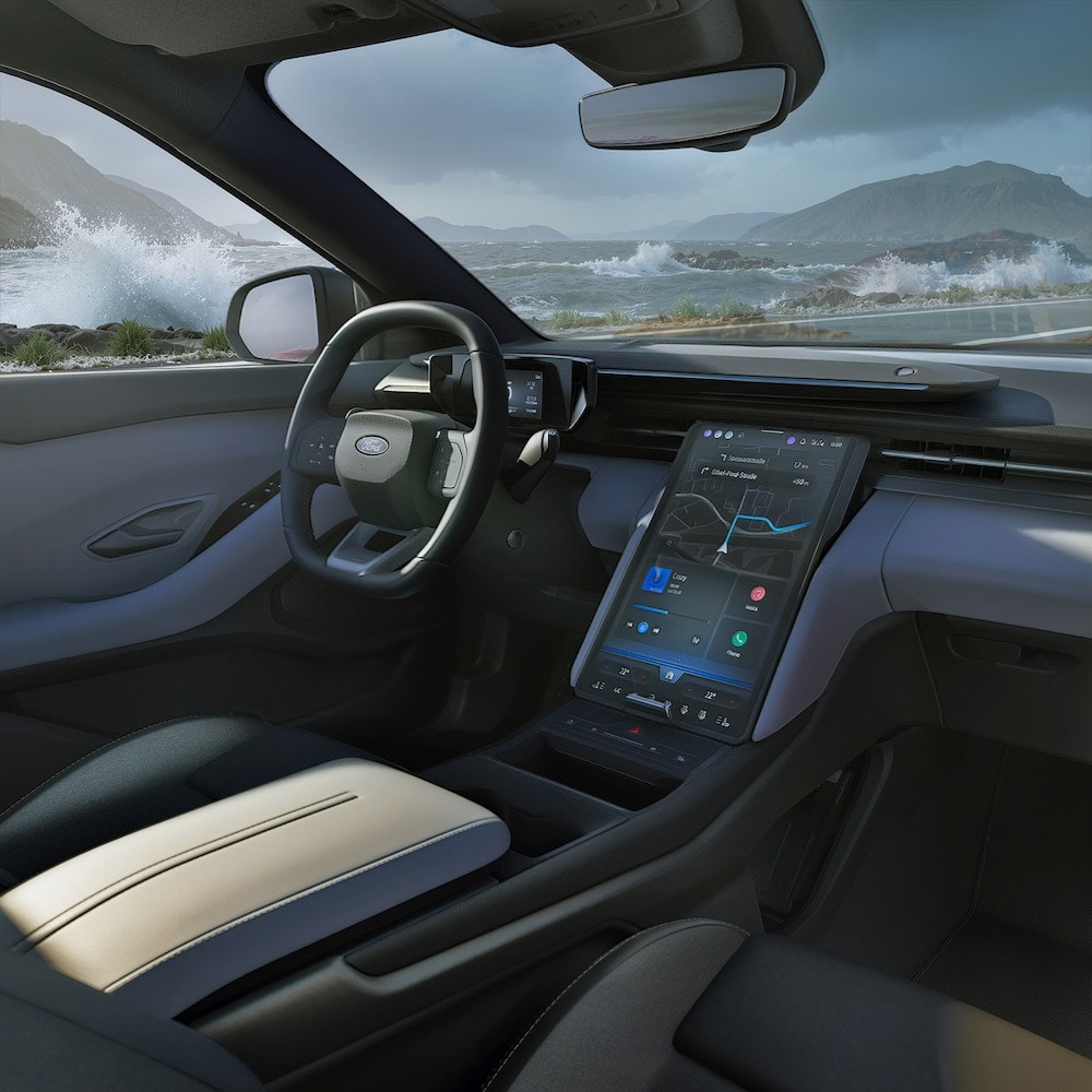 Interior of a Ford Capri showing the steering wheel, dashboard, and large vertical SYNC Move touchscreen.