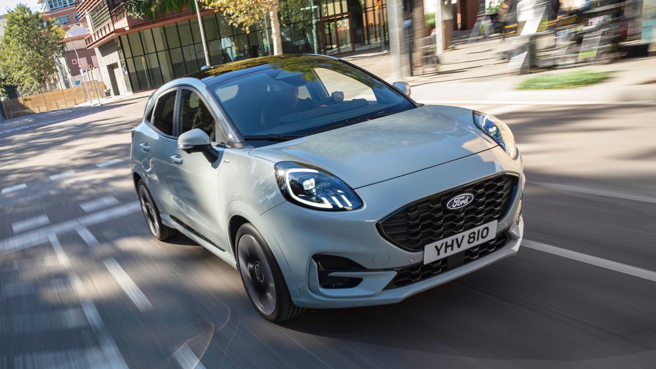 A grey Ford Puma driving on a road.