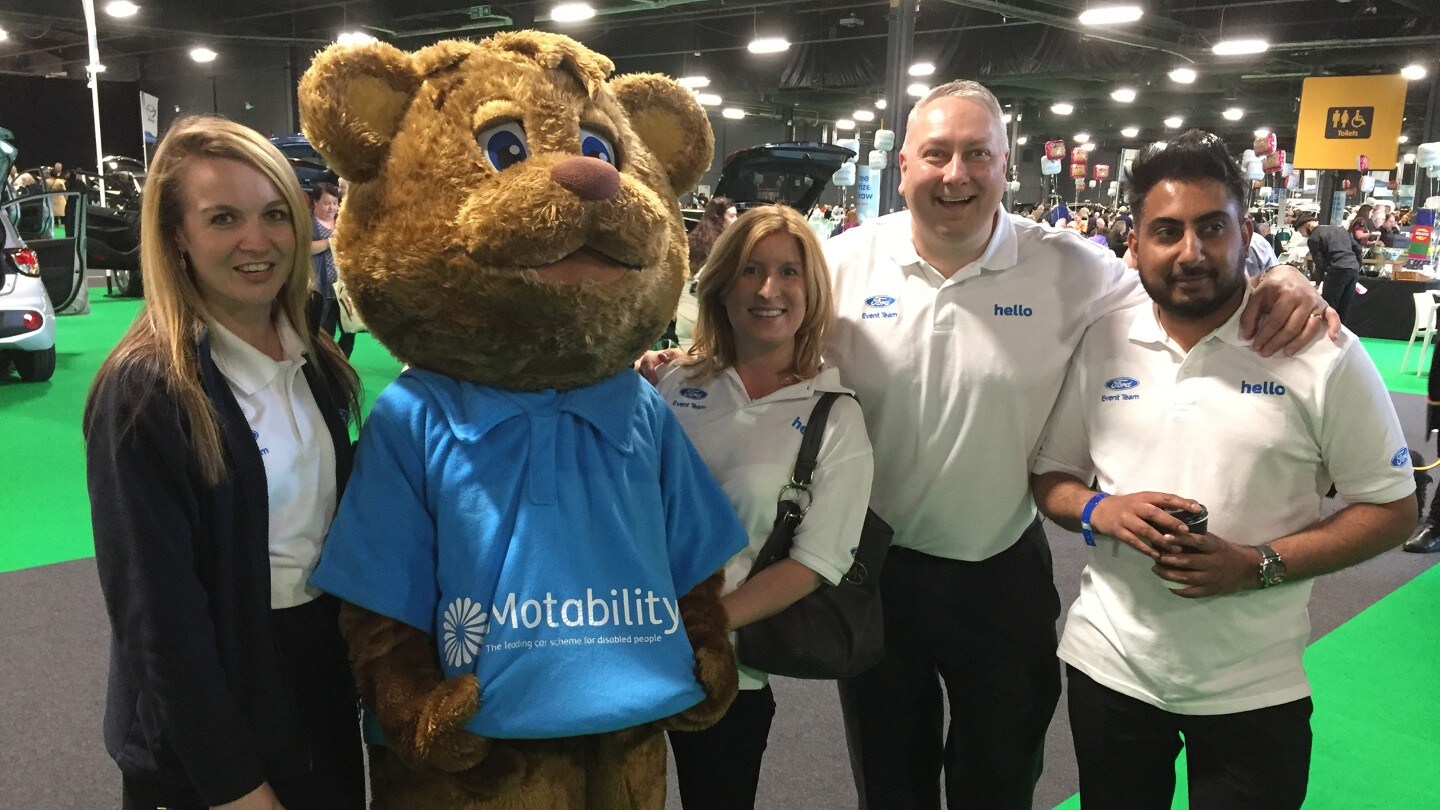 Ford Motability Mascot is taking a photo with a group