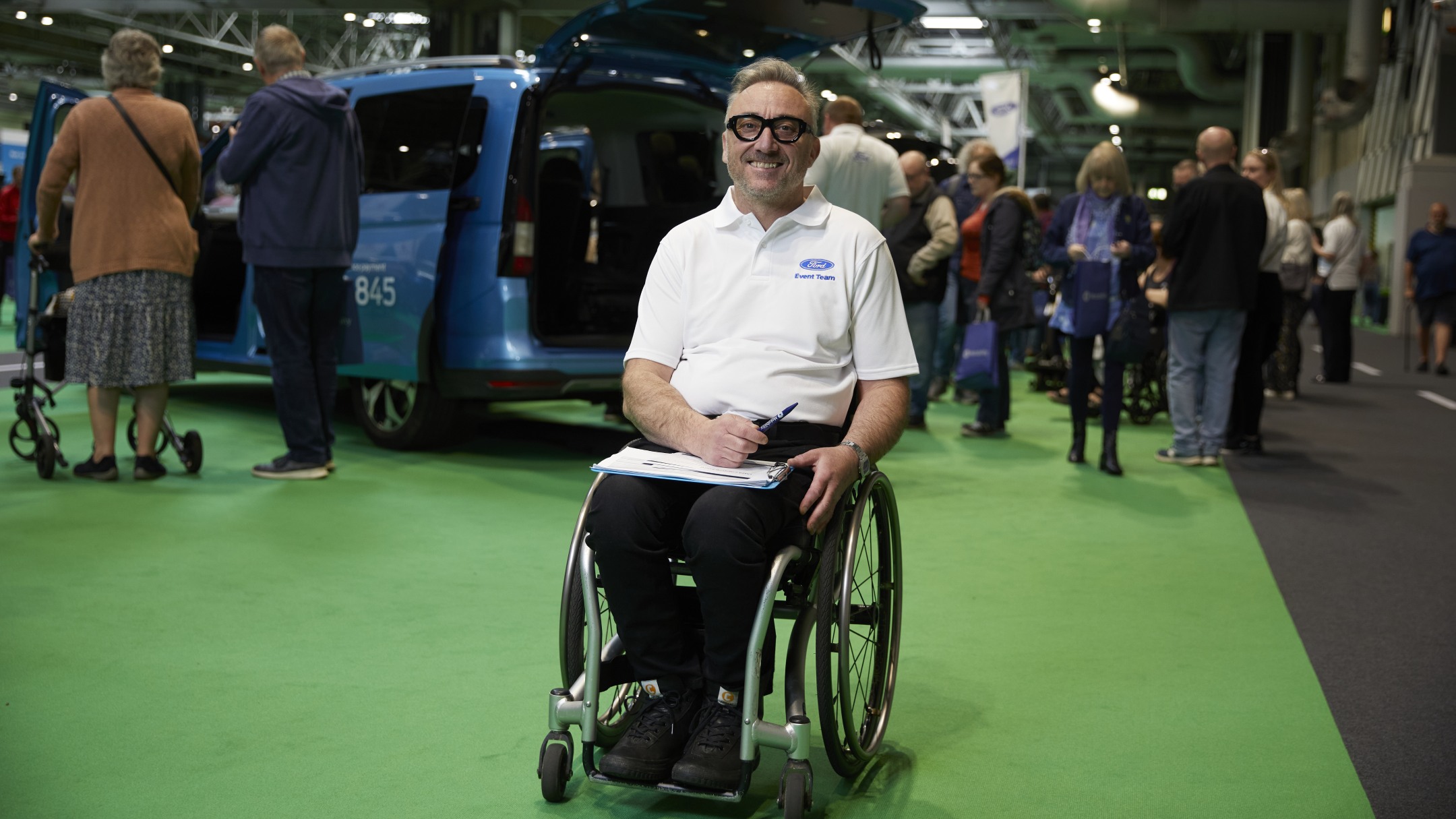 Smiling Ford event organiser sitting in a wheelchair