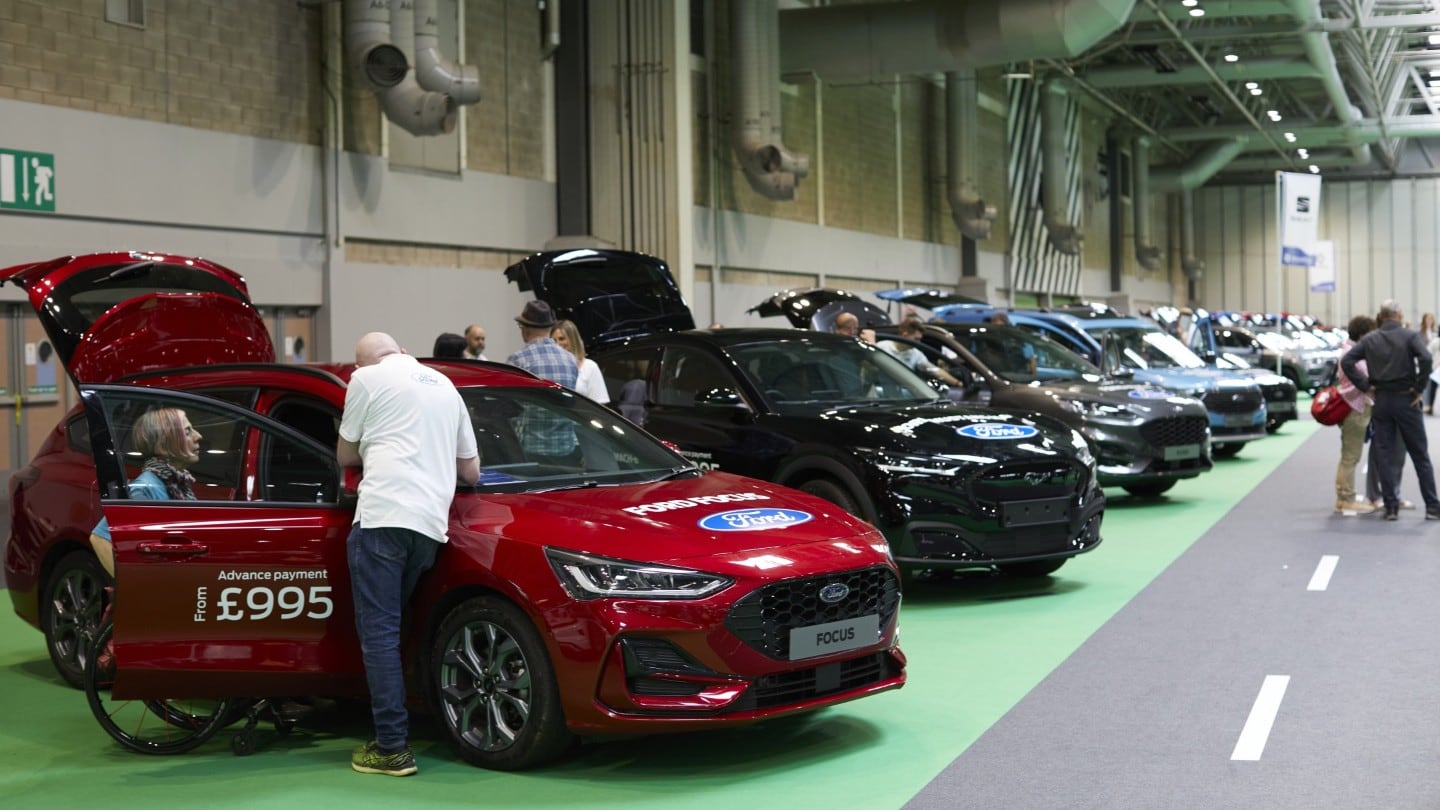 Handicapped people trying out various Ford vehicles